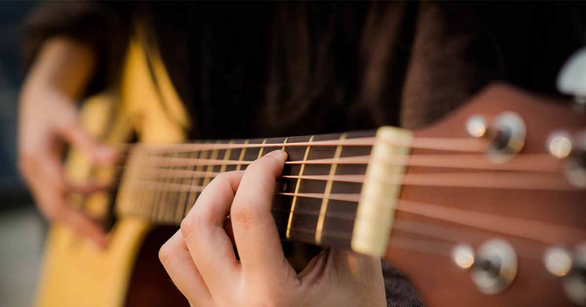 receiving-a-blessing Man playing the guitar, receiving a blessing through music
